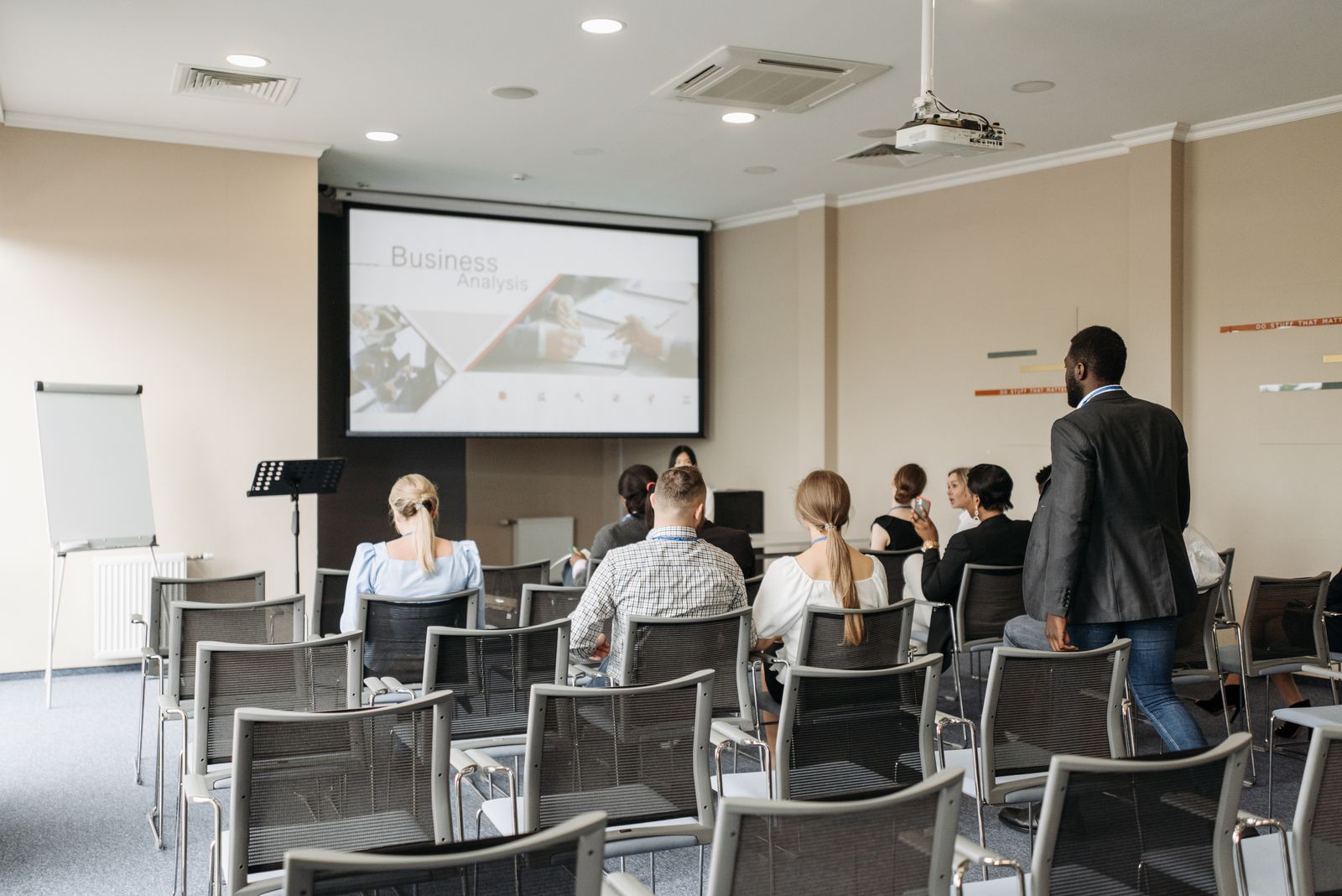 A presenter making the case to a room of colleagues.