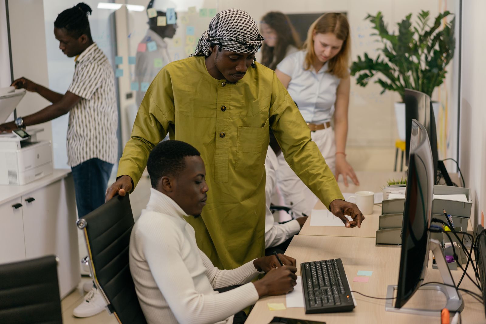 A diverse team at work across an open floor.